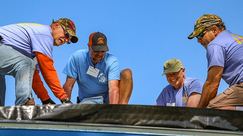 rebuild men repairing roof